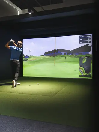 A player mid-swing in a bay.