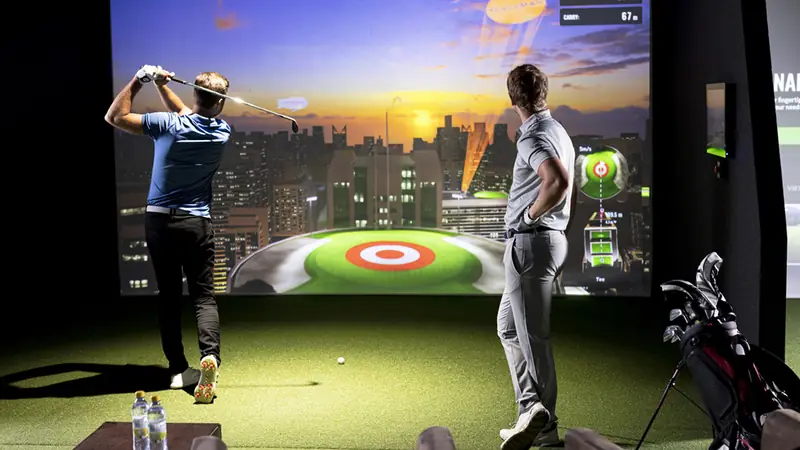 Two people playing a target game in a bay.